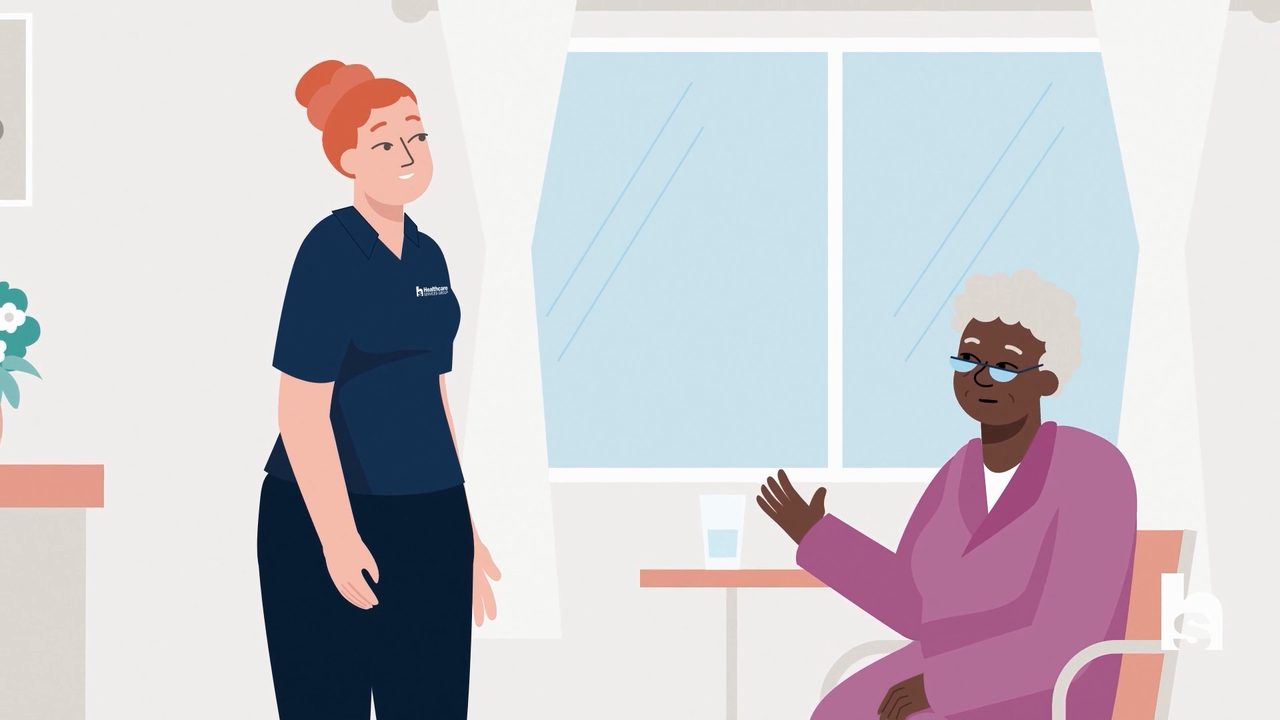 Still from an HCSG internal culture video series — caregiver listening to an elderly resident
