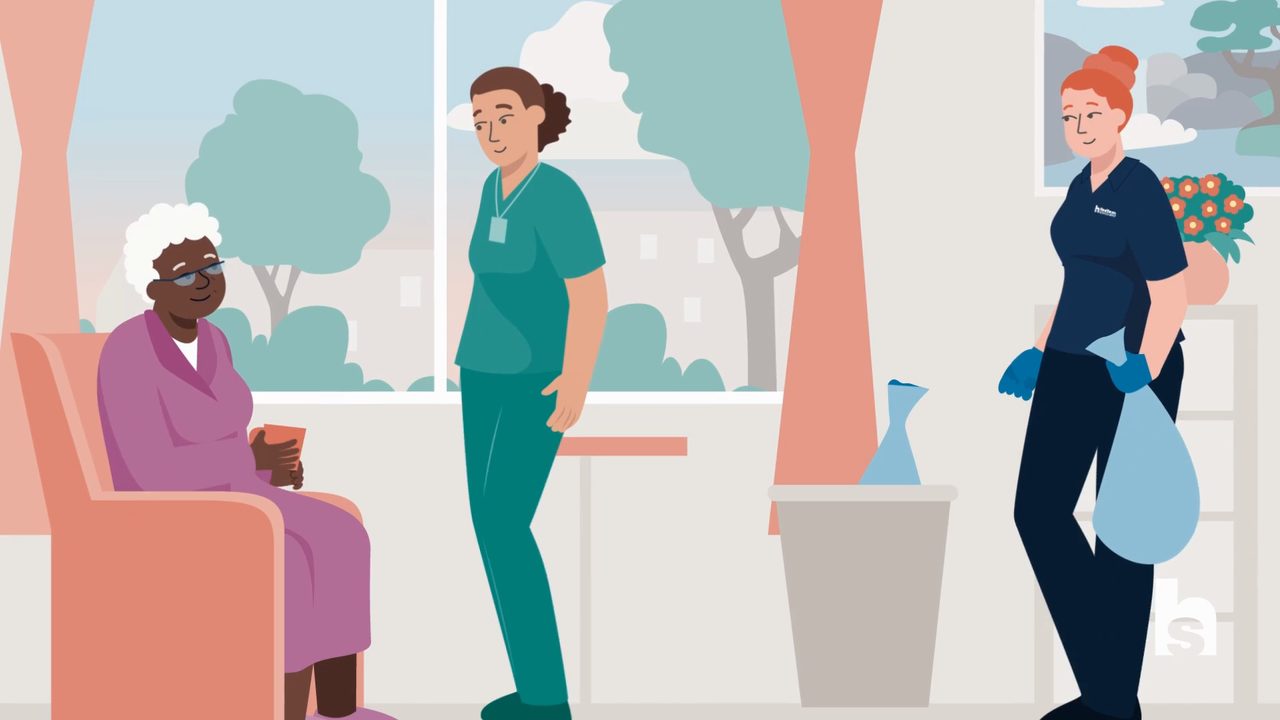 Animated care worker and housekeeper attending to an elderly resident in a care home room