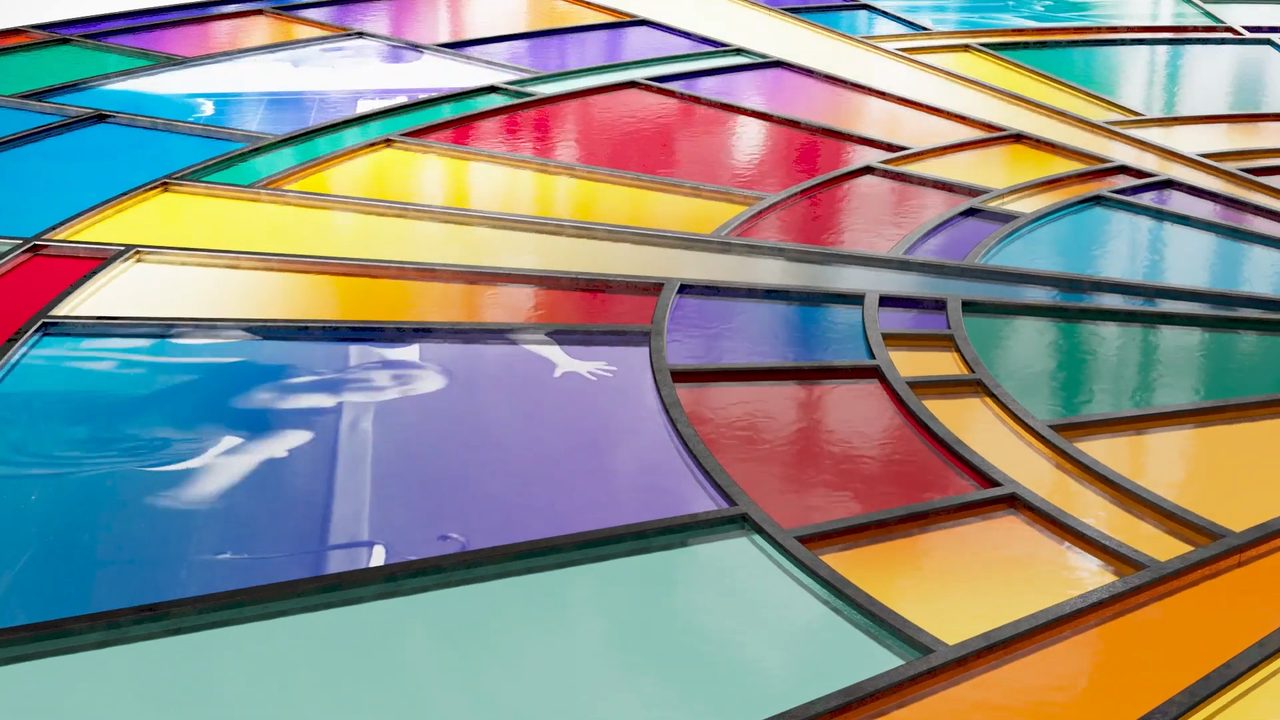 Close-up of a vibrant stained-glass window with curved lead lines — visual metaphor for denominational diversity