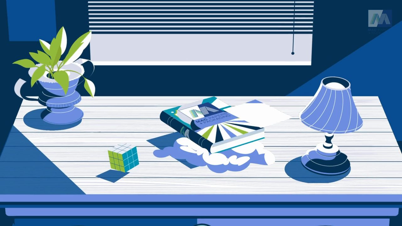 Animated desk scene with Mac Paper + Packaging catalog, from a Motifmotion sizzle reel